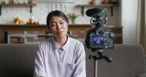 Young Woman Recording Video in Home Interior