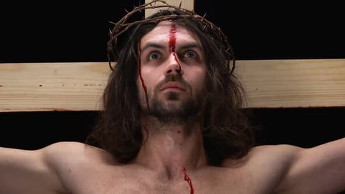 Jesus With Bleeding Body Crucified on Cross and Looking to Heaven, Close-Up