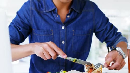 Young Adult Eating a Meal Indoors at Work
