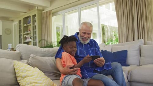Grandfather and Child Watching Mobile Phone Together