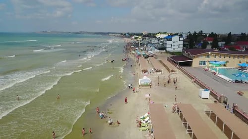 Aerial view of the luxury resort. Beach with tourists, sun loungers and umbrellas