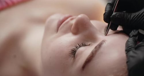 Eyebrow Shaping with Tweezers in a Beauty Salon
