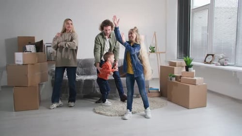 Happy New Home Owners Celebrate Relocation and Family Mortgage Young Parents and Cute Little