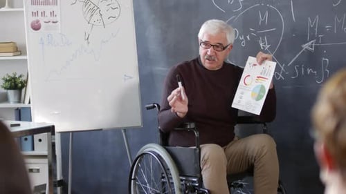 Mature Professor Explaining Graphs and Charts