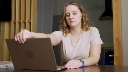 Woman Working On Laptop At Home