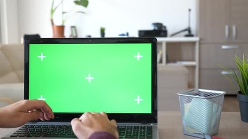 Revealing Shot of Man Working on the Computer with a Chroma Green Screen Mock Up