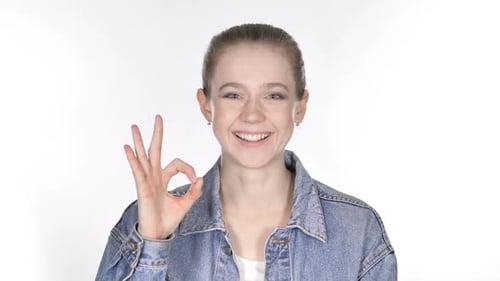 Young Woman Gives OK Hand Gesture on White