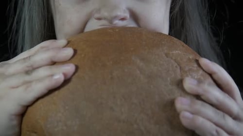 Young Child Eating Bread Close Up