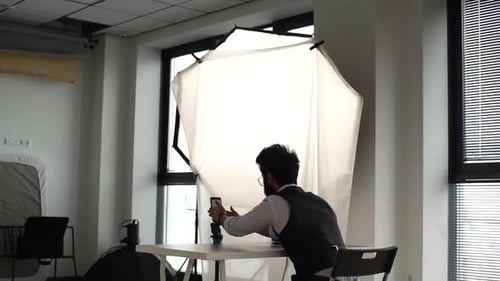 Back View of Unrecognizable Blogger Putting Phone on Tripod and Streaming Video Online Recording