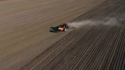 Tractor Cultivating Farmland in Rural Aerial View