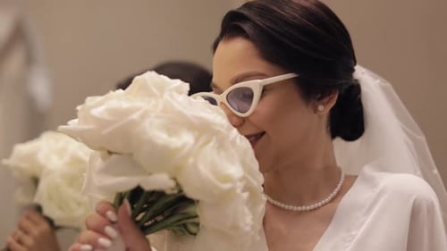 Smiling Bride with Bouquet Posing in Mirror