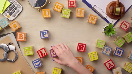 Woman Hand Arranging Wooden Cubes with Word POWER Top View