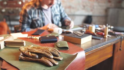 Artisan Craftsman Working With Leather on Desk