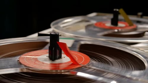 Vintage Reel to Reel tape recorder playing music close up of reel