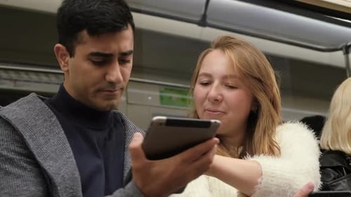 Man and woman talk sitting in subway