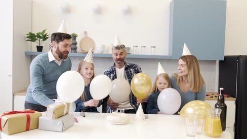 Happy Family Celebrating a Birthday in Modern Home