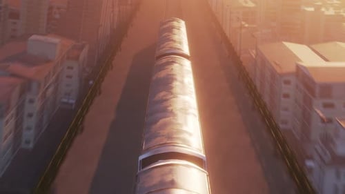 Vue aérienne du train dans la lumière chaude du coucher du soleil passant par la ville
