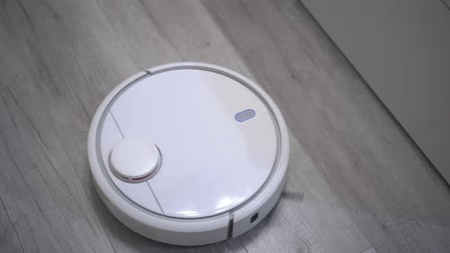 Robotic Vacuum Cleaner on Gray Wood Floor