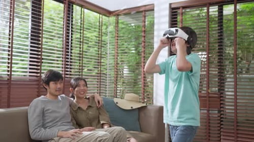 Teen Plays VR Game as Parents Watch