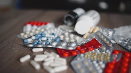 Huge Number of Pills Multi-colored tablets.Beautiful Drop Pills on the Table. White, Blue, Red and