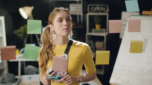 Satisfied Business Woman Looking on Ideas Board in Hipster Office.