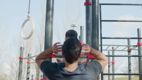 Two Men Working Out Outdoors in Fitness Park