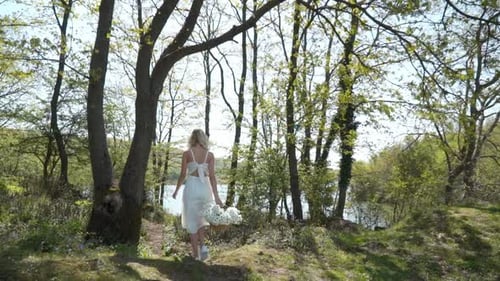 Beautiful Woman Walking With Daisies In The Forest