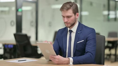 Professional Man Working On Tablet In Office