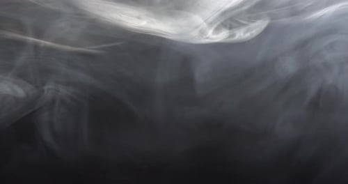 Wispy White Smoke Flowing on Dark Background