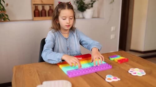 Little girl playing with big silicone popit, simple dimple, bubble fidget toy