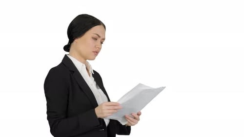 Serious Cute Businesswoman Reading Documents on White Background