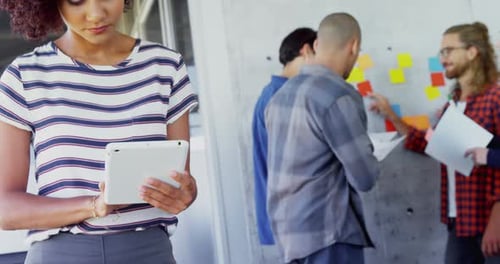Collaborative Team Working at Office with Tablet