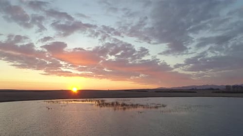 Flying To Sun Over Lake