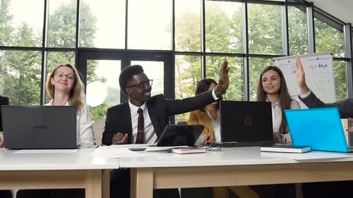 Diverse Team Celebrates Success with High Five