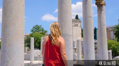4K Woman Walking in Slow Motion Next to Ancient Greek Columns in the Roman Forum of Athens, Greece