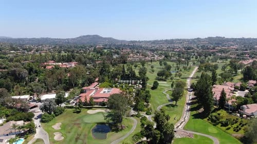 Aerial View of Golf in Upscale Residential Neighborhood.