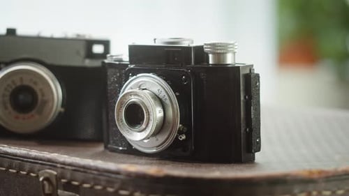 Vintage Camera Collection on Old Suitcase