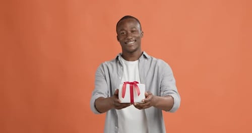Man Giving Gift, Smiling With Happiness
