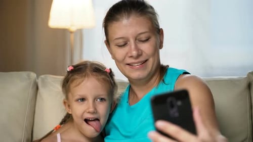 Smiling Mother and Child Taking Selfie with Phone