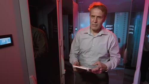 Middle-Aged Man Walking in Data Center