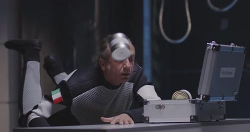 Man Looks at Floating Cans in Futuristic Lab