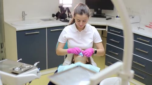 Dentist Working on Patient in Modern Office