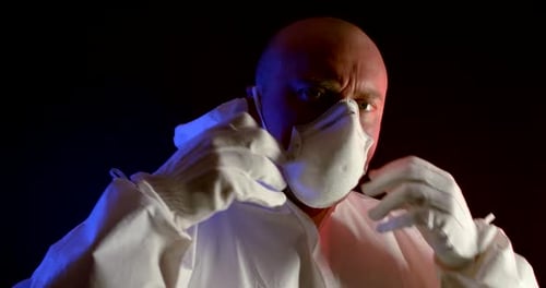 Person in Protective Hazmat Suit Adjusting Face Mask