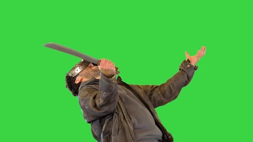 Masked Man with Blade Swings Against Green Screen