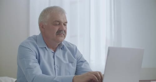Tired and Exhausted Office Worker Is Feeling Headache During Work with Laptop in Daytime, Feeling
