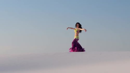 Woman Performs Belly Dance in Desert Costume