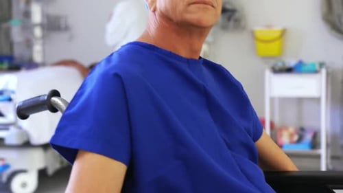 Male patient sitting on wheelchair in the ward 4k