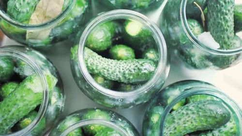 Cucumbers in Jars are Returned to the Table Top View