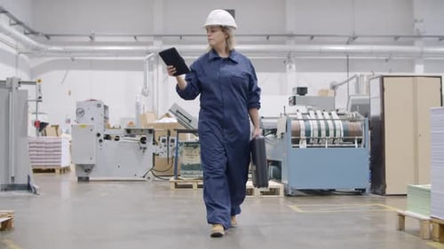 Middle Aged Female Factory Engineer with Tablet and Toolkit Box
