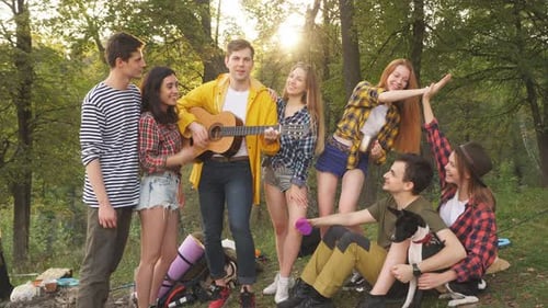 Friends Gather in Forest for Music and Fun